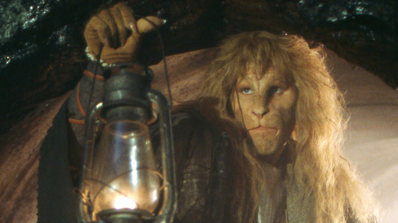 Vincent (Ron Perlman) holding a lamp on Beauty and the Beast