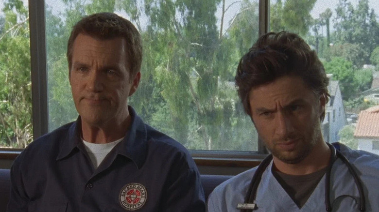 Janitor (Neil Flynn) sitting next to JD (Zach Braff) on 'Scrubs'.